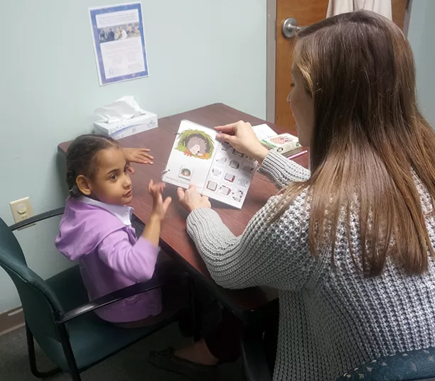 Speech therapist working with young child