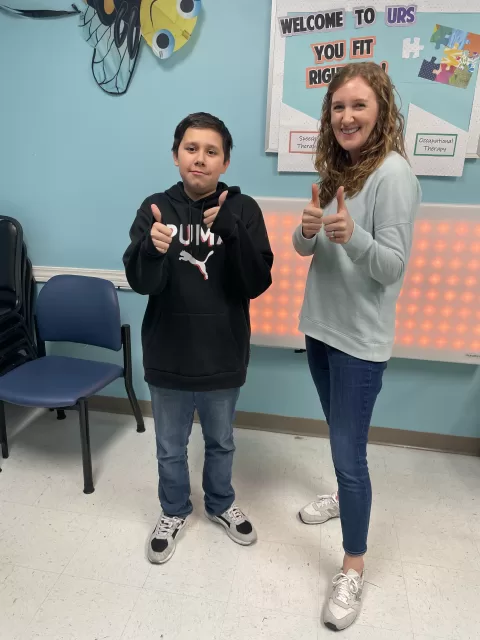 Patient using augmentative communication device