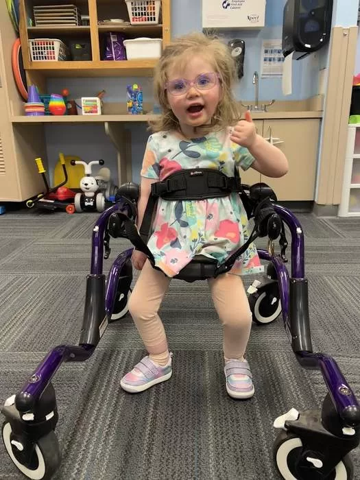 Child in gait trainer